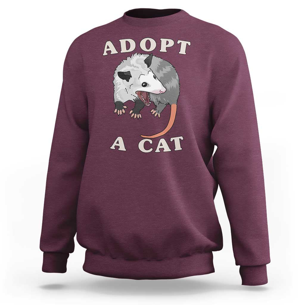 Maroon sweatshirt with 'ADOPT A CAT' graphic on front, crewneck long sleeves