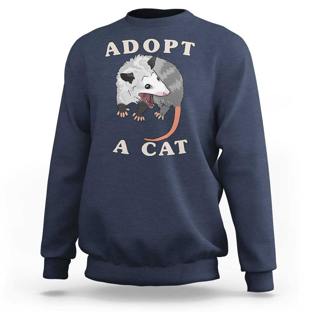 Navy sweatshirt with 'ADOPT A CAT' graphic on front, crewneck long sleeves