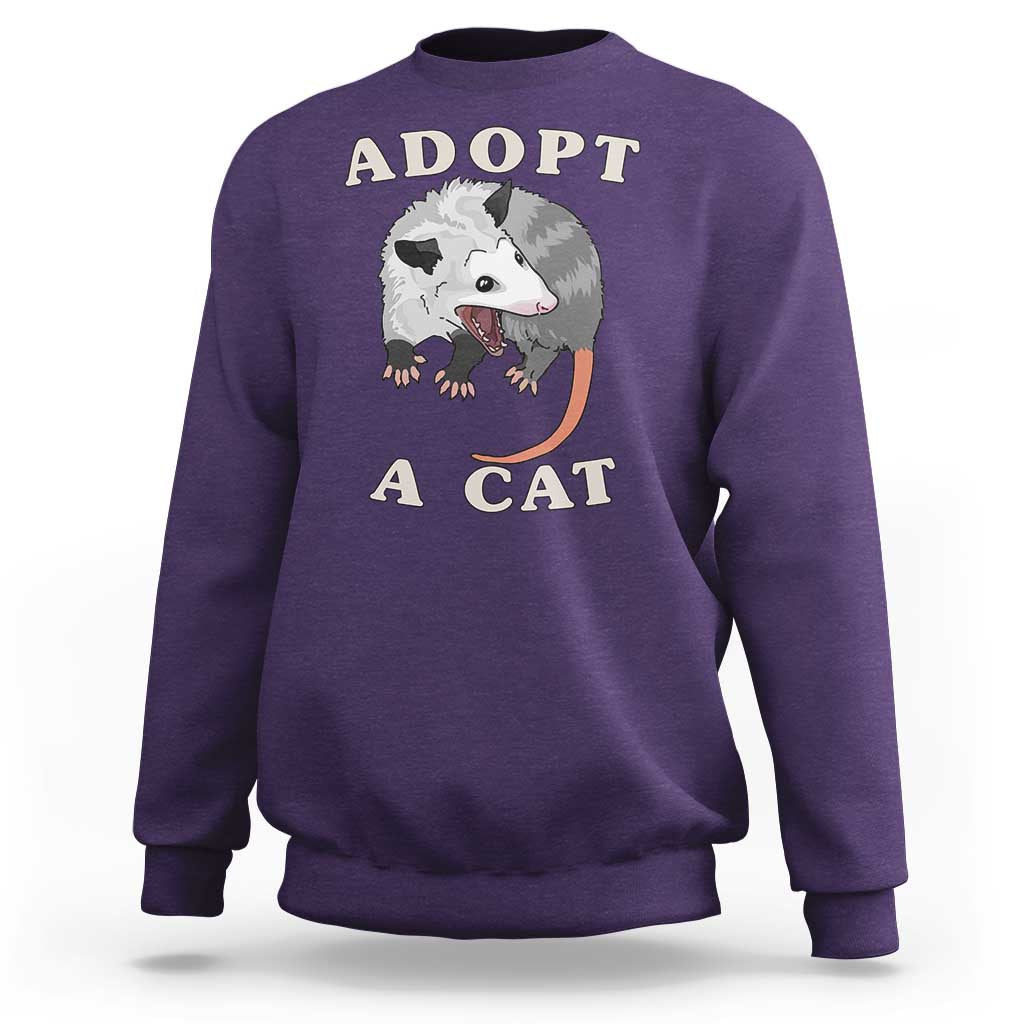 Purple sweatshirt with 'ADOPT A CAT' graphic on front, crewneck long sleeves