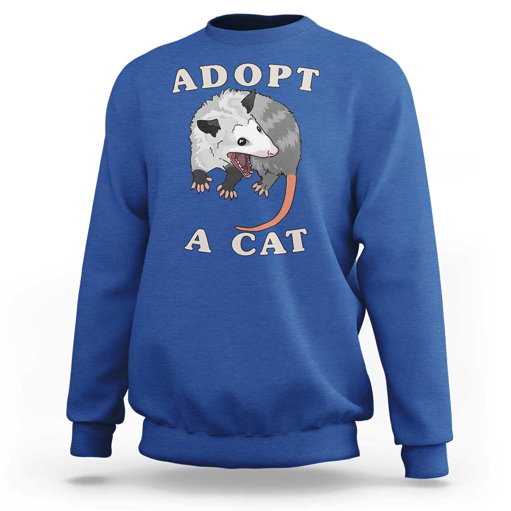 Blue sweatshirt with 'ADOPT A CAT' graphic on front, crewneck long sleeves