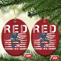Two red round Christmas ornaments with gold hanging loops and “Support Our Troops”