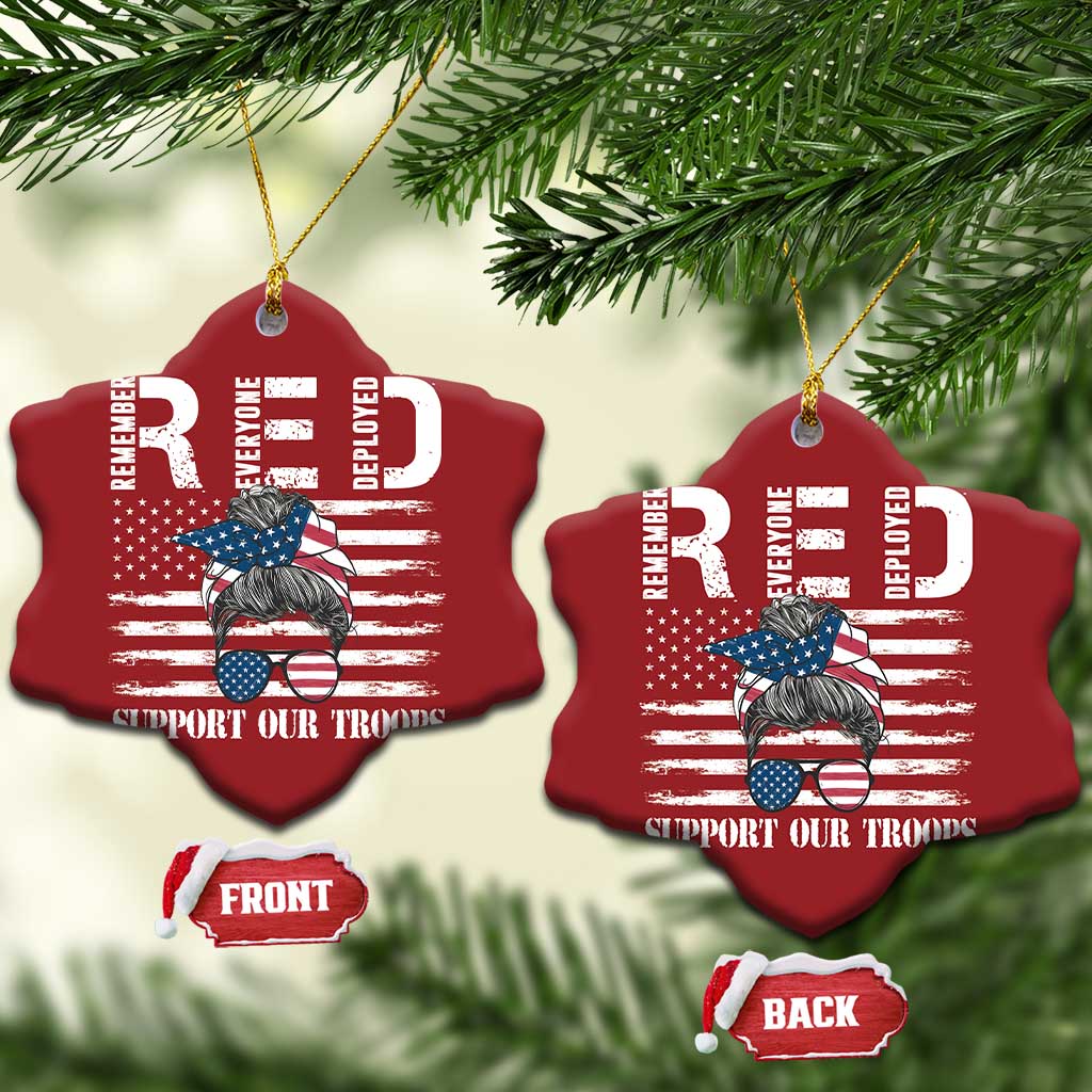 Two red heart-shaped Christmas ornaments with gold loops and “Support Our Troops”