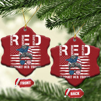 Two red heart-shaped Christmas ornaments with gold loops and “Support Our Troops”