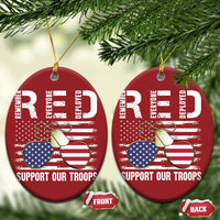 Two red round Christmas ornaments with gold strings, eagle and flags, "Support Our Troops"