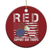 Red round Christmas ornament with gold string, dog tag eagle graphic, "Support Our Troops"