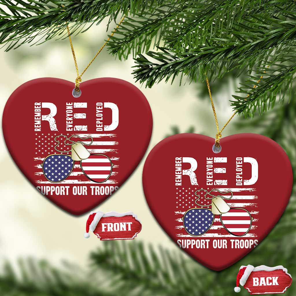 Two red heart-shaped Christmas ornaments with gold strings, eagle graphic and "Support Our Troops"