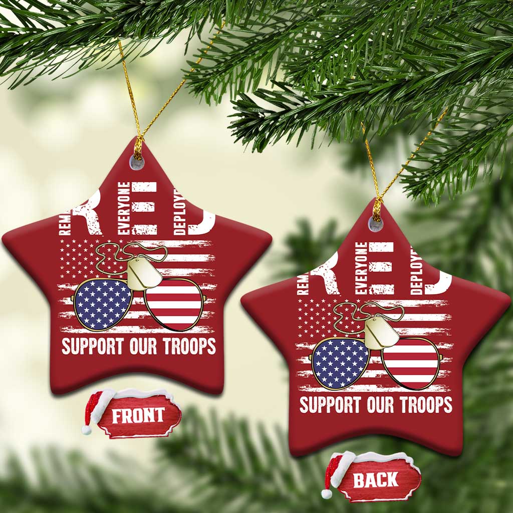 Two red star-shaped Christmas ornaments with gold strings, eagle and U.S. flag, "Support Our Troops"
