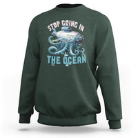 Dark forest green crewneck sweatshirt with long sleeves and octopus-submarine front graphic print
