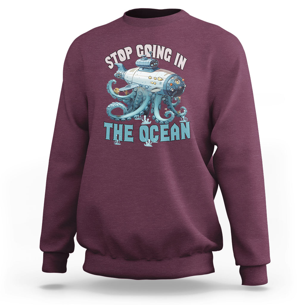 Maroon crewneck sweatshirt with long sleeves and octopus-submarine front graphic print