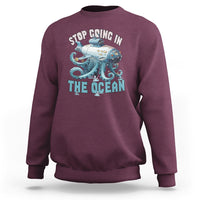 Maroon crewneck sweatshirt with long sleeves and octopus-submarine front graphic print