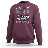 Maroon crewneck sweatshirt with “Stop Going In The Ocean” submarine graphic on chest
