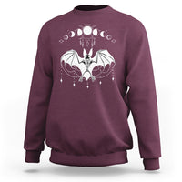 Maroon crewneck sweatshirt with white bat witch graphic across the chest