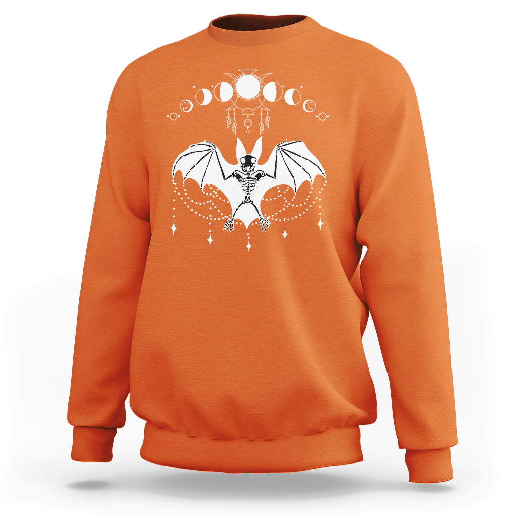 Orange crewneck sweatshirt with white bat witch graphic across the chest