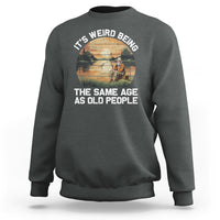 Dark heather gray crewneck sweatshirt with front fishing-themed slogan graphic, long sleeves.
