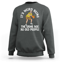 Dark heather gray crewneck sweatshirt with pickleball graphic and “THE SAME AGE AS OLD PEOPLE”.