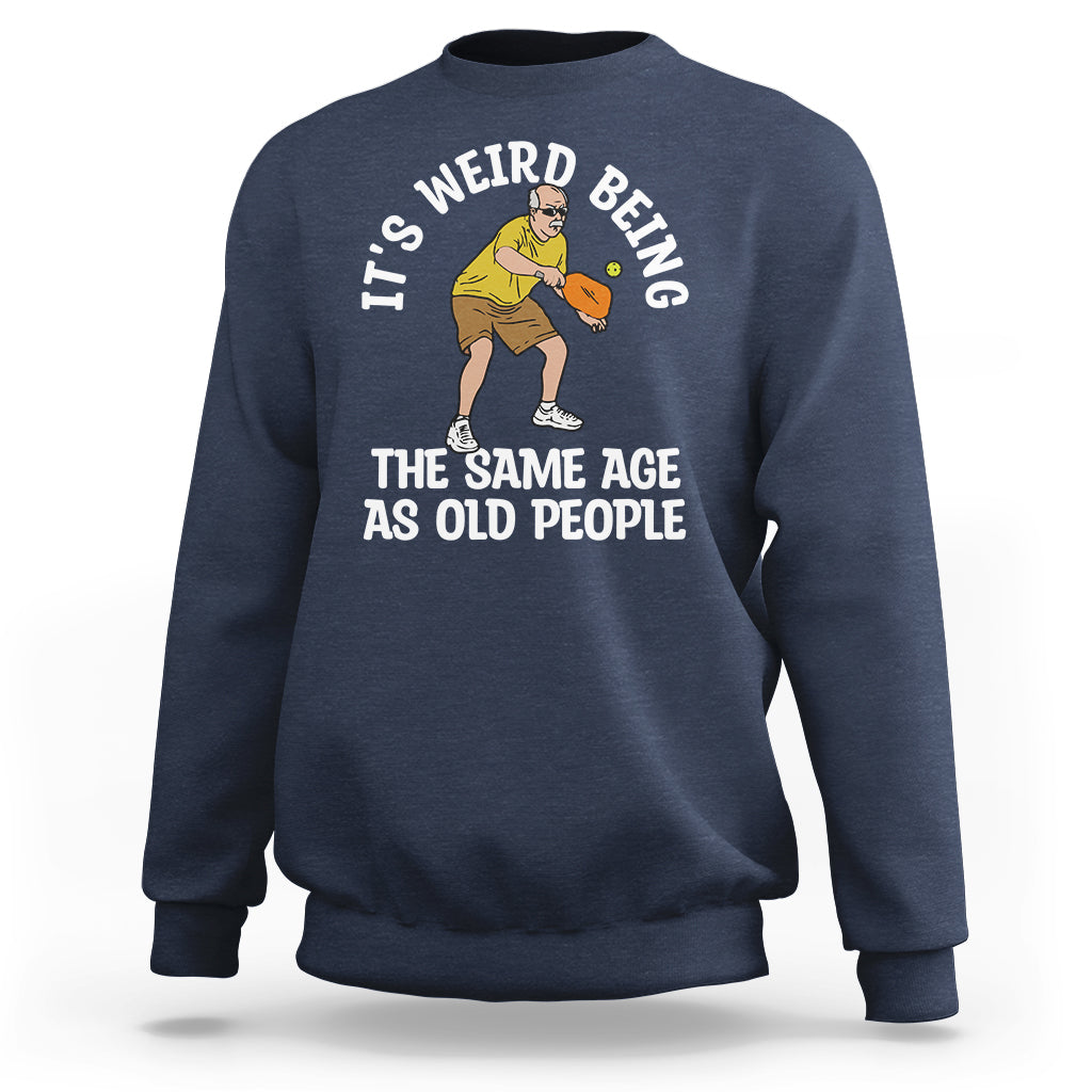 Navy crewneck sweatshirt with pickleball graphic and “THE SAME AGE AS OLD PEOPLE” text.