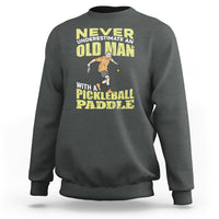 Dark heather gray sweatshirt with crew neck and front pickleball paddler graphic