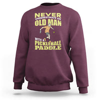 Maroon sweatshirt with crew neck and front pickleball paddler graphic
