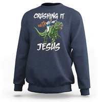 Navy crewneck sweatshirt with dinosaur graphic and text "CRUSHING IT with JESUS"