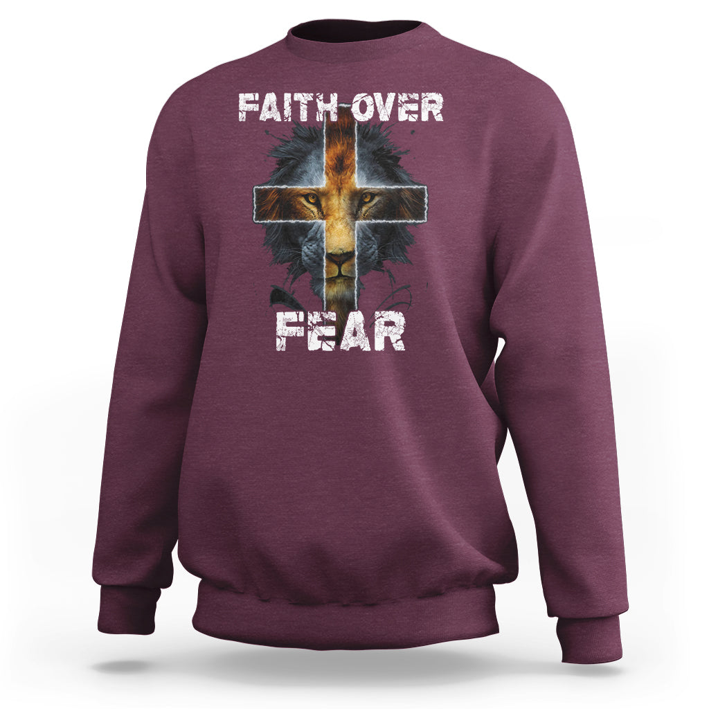 Maroon crewneck sweatshirt with cross graphic and "FAITH OVER"/"FEAR" text