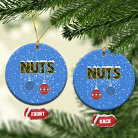 Blue ceramic round Christmas ornament with “NUTS” and hanging bauble icons; gold loop.