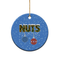 Blue ceramic round Christmas ornament with “NUTS” and hanging bauble icons; gold hook.
