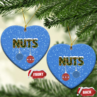 Blue ceramic heart-shaped Christmas ornaments with “NUTS” and hanging bauble icons; gold loops.