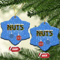 Blue ceramic star-shaped Christmas ornaments with “NUTS” and hanging bauble icons; gold loops.