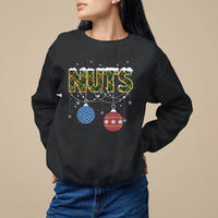 Black Christmas sweatshirt with 'NUTS' graphic and hanging ornament decor