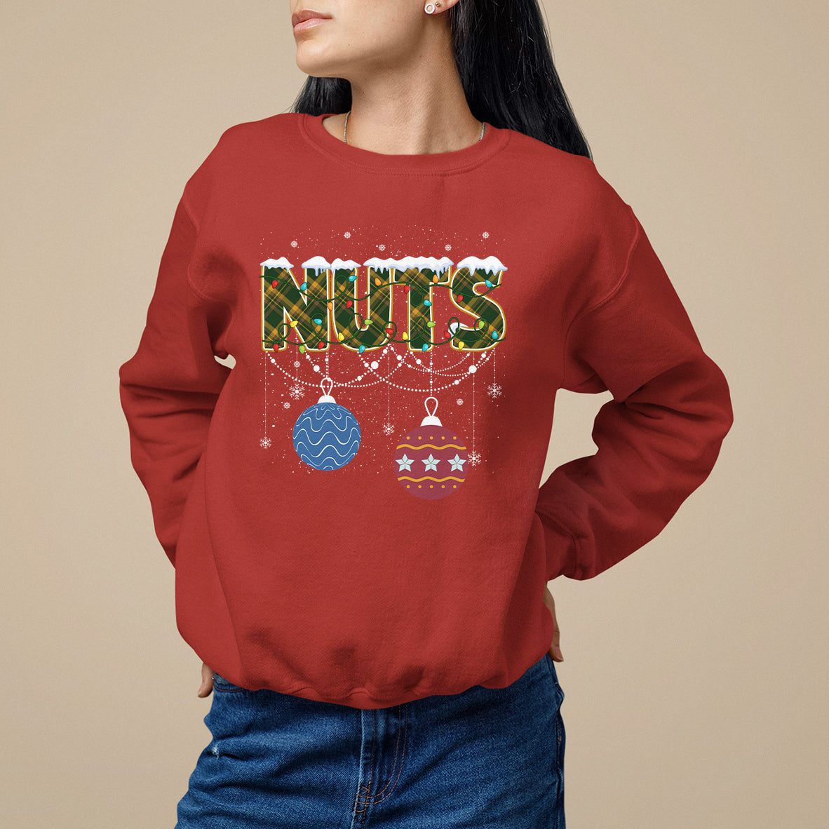 Red Christmas sweatshirt with 'NUTS' graphic and hanging ornament decor
