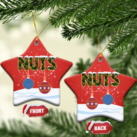 Red ceramic sweater-shaped Christmas ornament with “NUTS,” with gold hanging string.