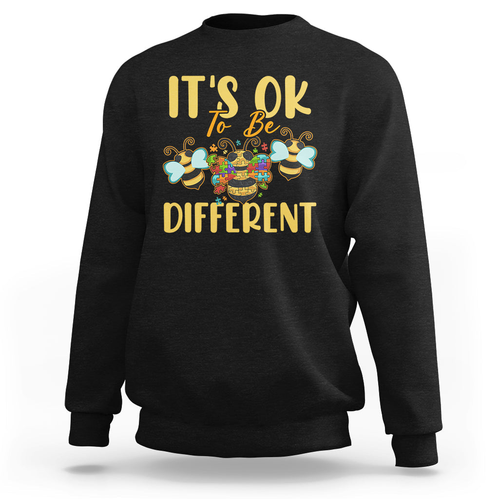 Black sweatshirt with “It’s ok to be different” bee graphic on the front.