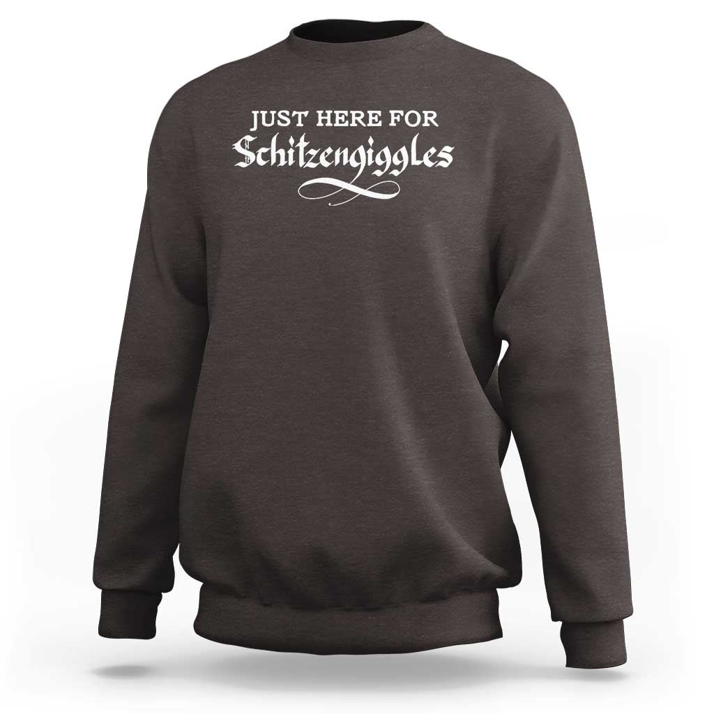 Dark chocolate crewneck sweatshirt with “JUST HERE FOR Schitzeniggles” graphic on chest