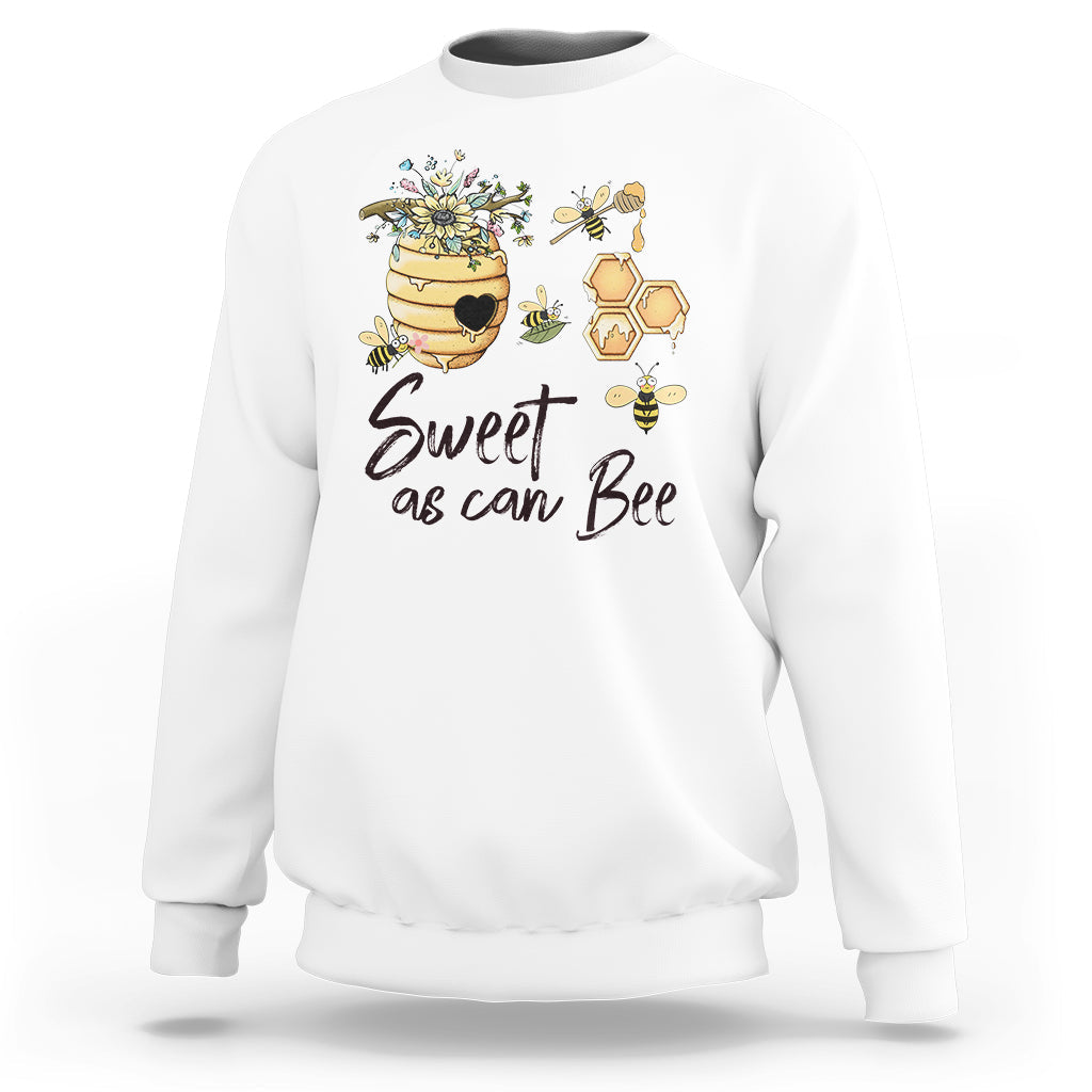 White bee graphic sweatshirt with honeycomb and flowers, text "Sweet as can Bee".