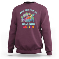Maroon crewneck sweatshirt with colorful turtle and autism acceptance graphic on chest