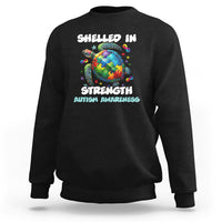 Black autism awareness sweatshirt with turtle globe “Shelled In Strength” front print