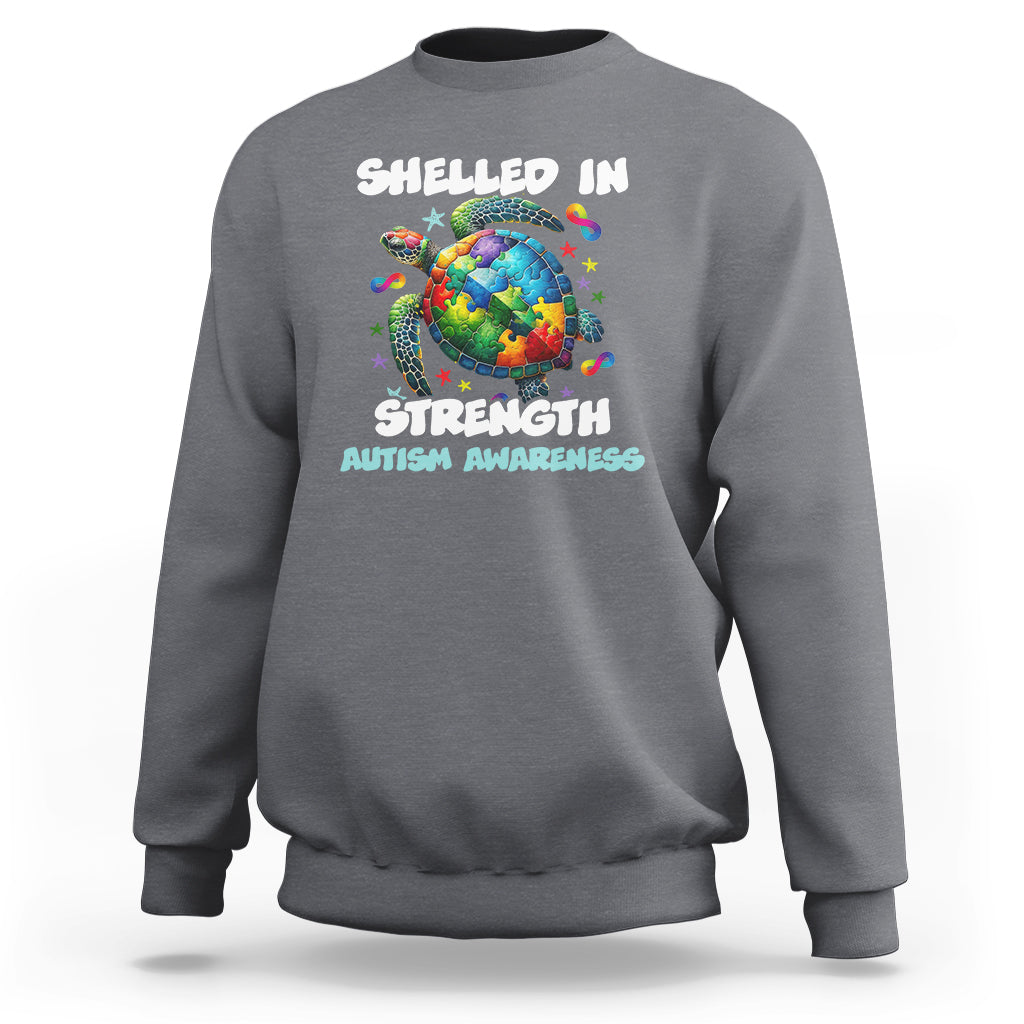 Dark heather gray autism awareness sweatshirt with turtle globe “Shelled In Strength” graphic