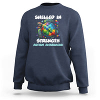 Navy autism awareness sweatshirt with turtle globe “Shelled In Strength” front graphic