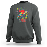 Dark heather sweatshirt with turtle graphic and 'SEE THE ABLE, NOT THE LABEL' slogan