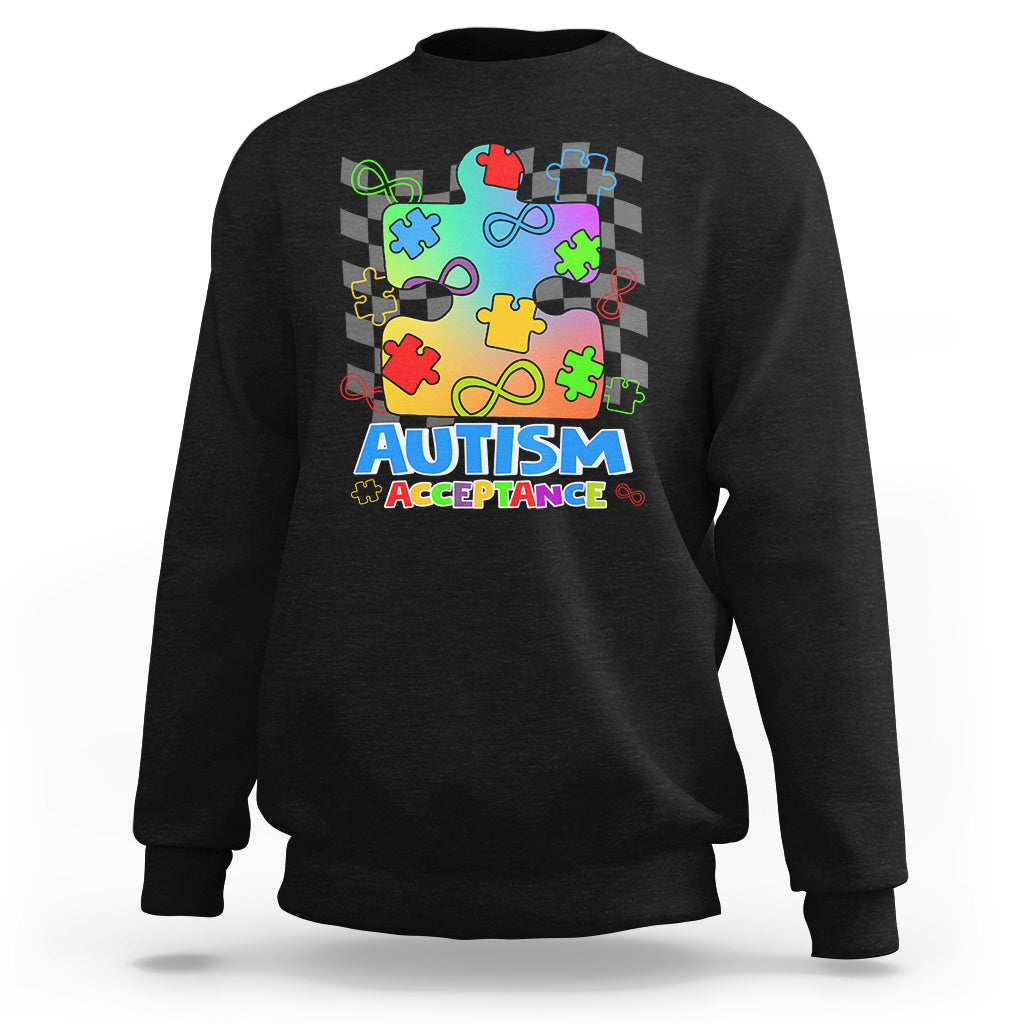 Black crewneck sweatshirt with colorful puzzle piece Autism Acceptance graphic on front