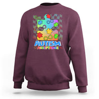 Maroon crewneck sweatshirt with colorful puzzle piece Autism Acceptance graphic on front