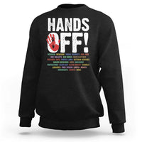 Black crewneck sweatshirt with “HANDS OFF!” graphic on the back