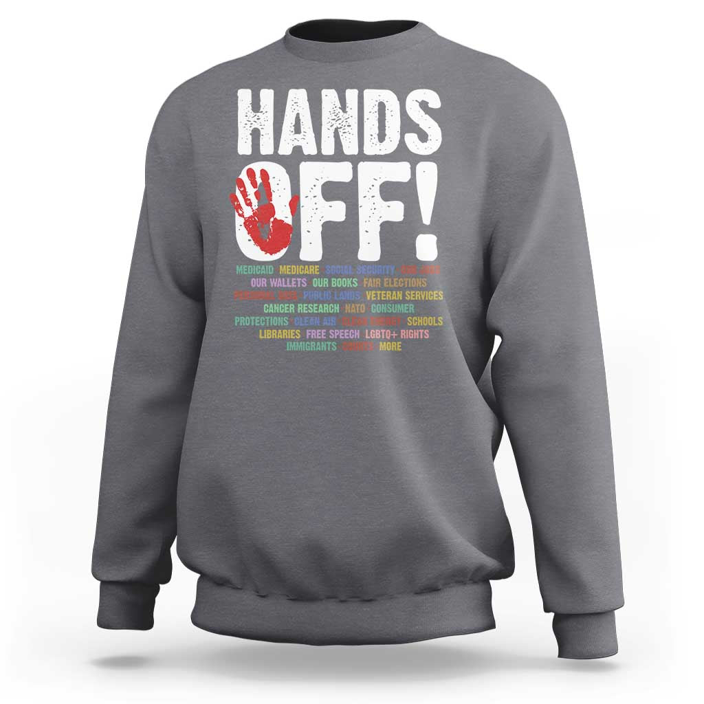 Dark heather gray crewneck sweatshirt with “HANDS OFF!” graphic on the back