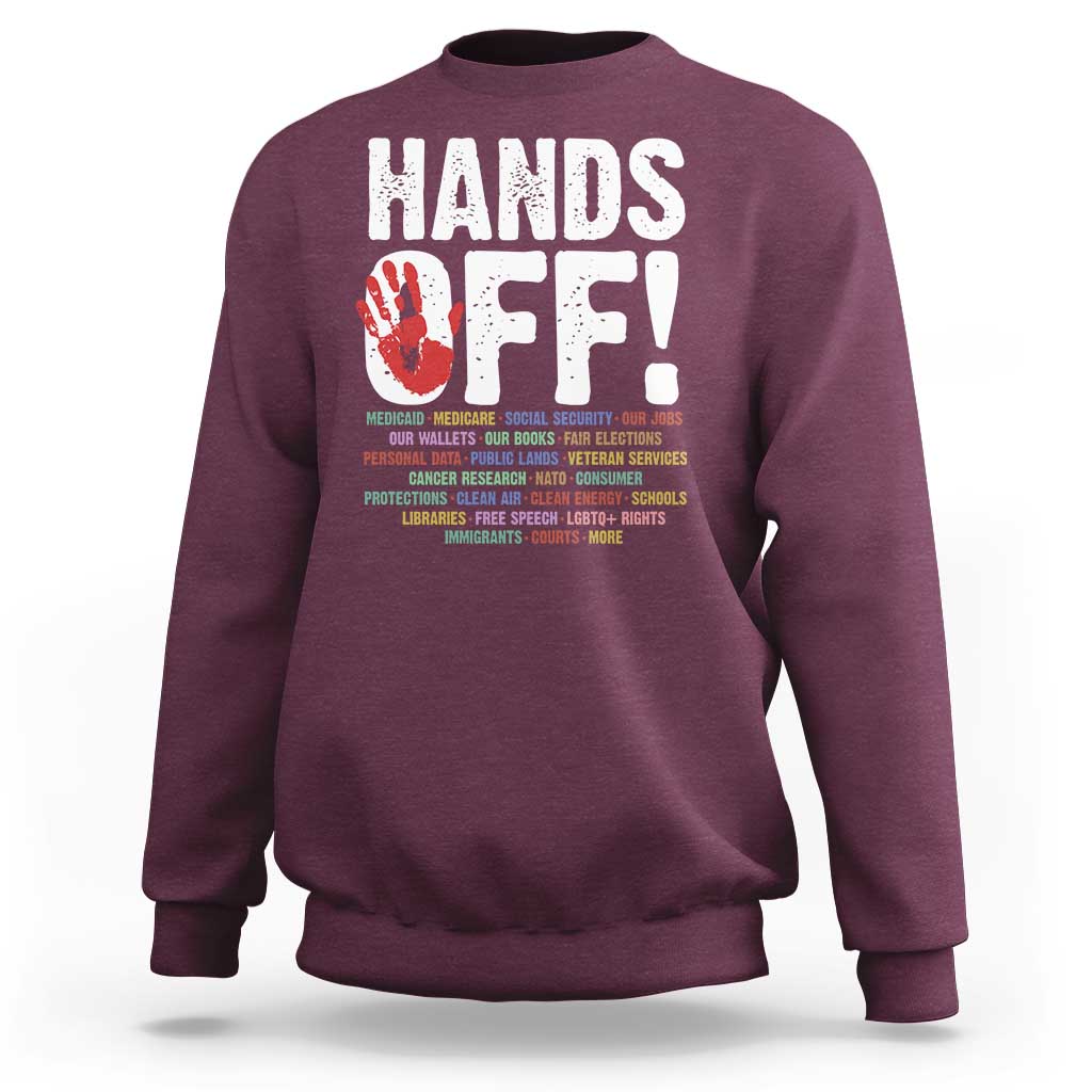 Maroon crewneck sweatshirt with “HANDS OFF!” graphic on the back