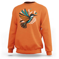 Orange kids sweatshirt with colorful bird and feather graphic on the front