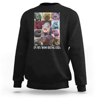Black crewneck sweatshirt with colorful hippo graphic on front
