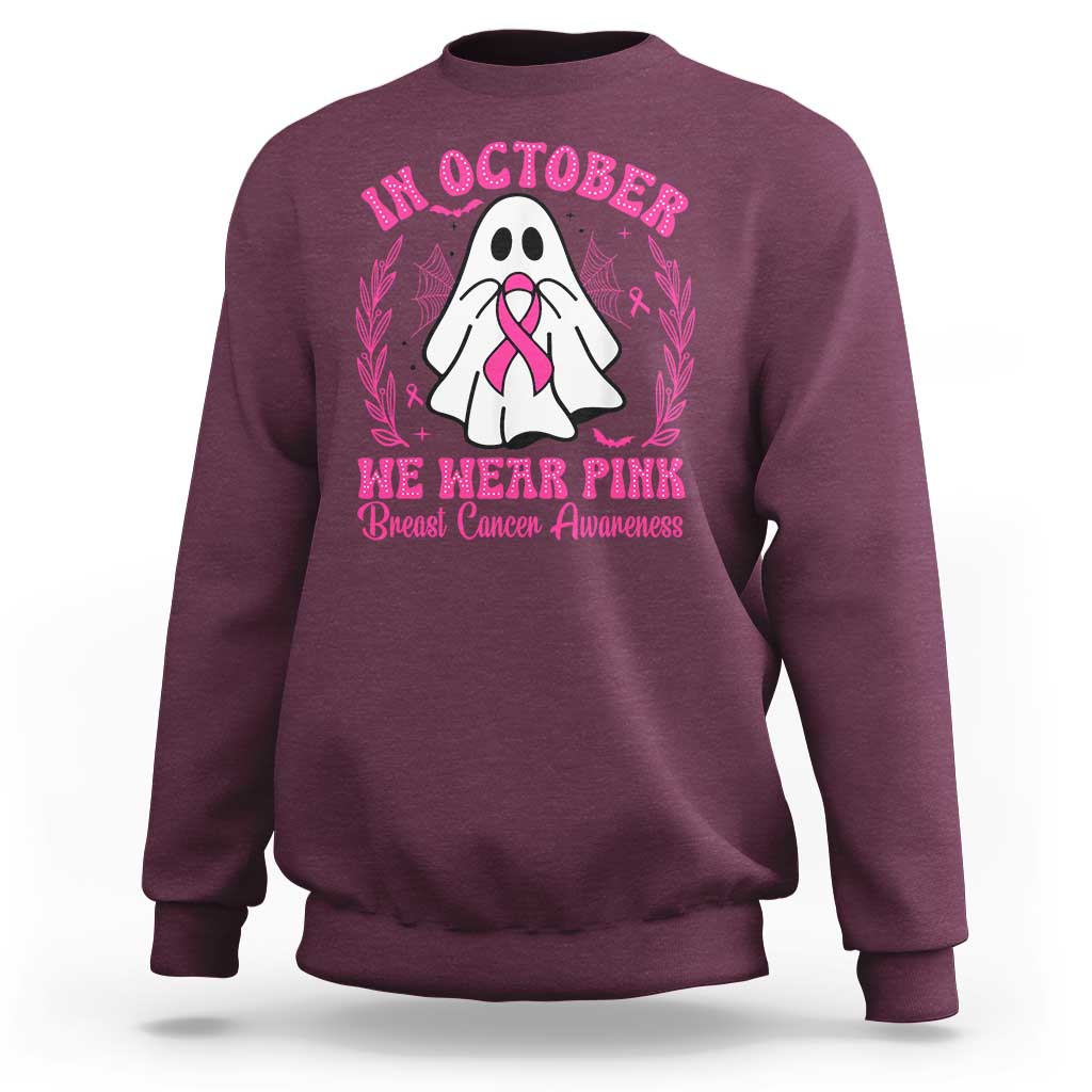 Maroon crewneck sweatshirt with pink breast cancer awareness graphic on back.