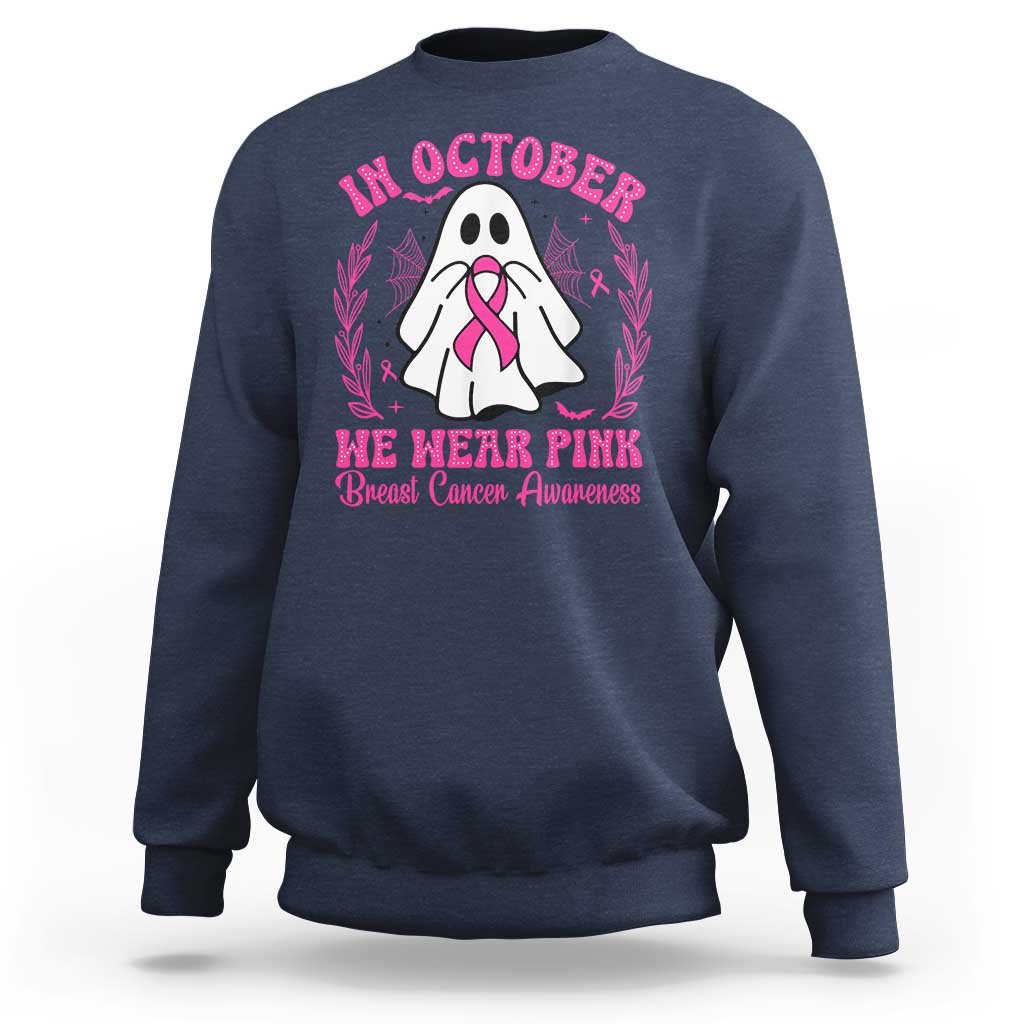 Navy crewneck sweatshirt with pink breast cancer awareness graphic on back.
