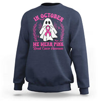 Navy crewneck sweatshirt with pink breast cancer awareness graphic on back.