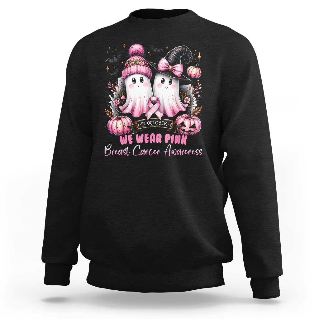 Black crewneck sweatshirt with pink ghost graphic and “We Wear Pink” text